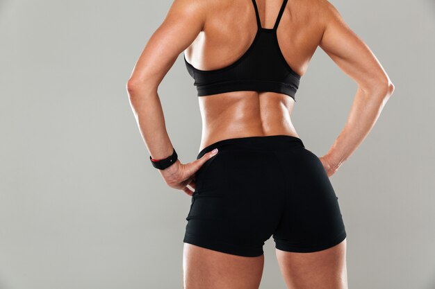 Back view cropped image of a healthy muscular woman