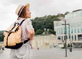 Free photo back view curly woman traveling alone