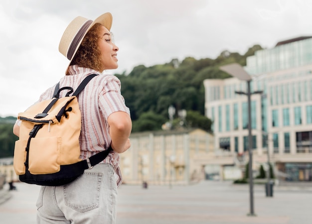 Back view curly woman traveling alone