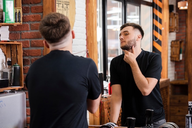 Back view customer checking his beard