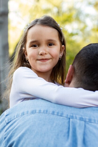 Back view father holding girl