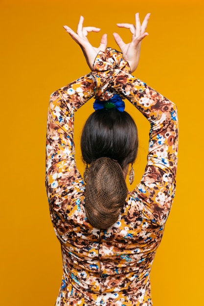 Free photo back view flamenca woman raising hands