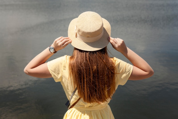 Back view girl near lake