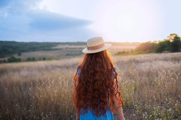 Back view girl wearing hat