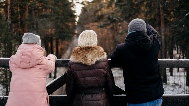 Back view of group of friends outdoors in winter