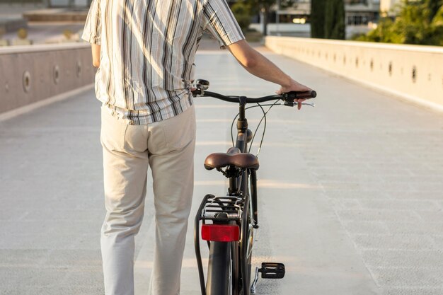 Back view hands holding bike's handlebars