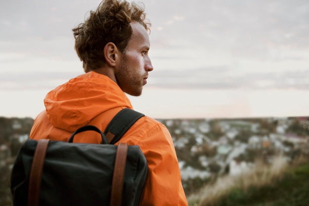 Free Photo back view of man admiring nature while on a road trip