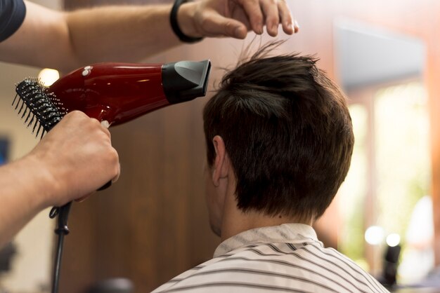 Back view man getting a haircut