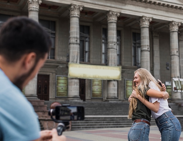 Free photo back view man photographing women