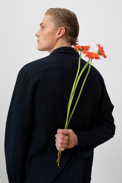 Back view man posing with flowers