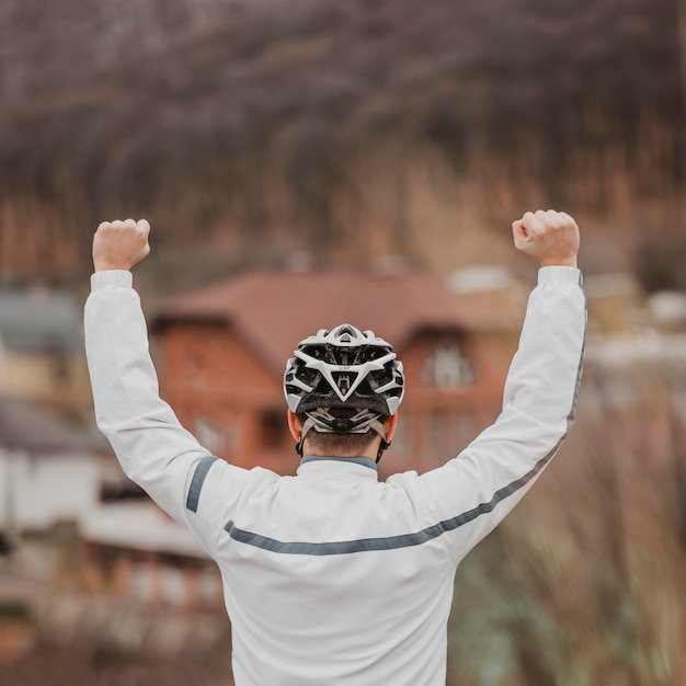 Free photo back view man with bicycle safety hat on his head