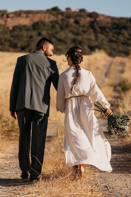 Back view married couple walking together