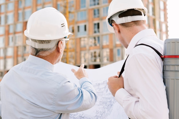 Free Photo back view men looking at building design