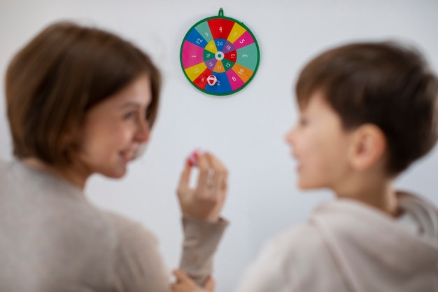 Free Photo back view mother and boy playing game