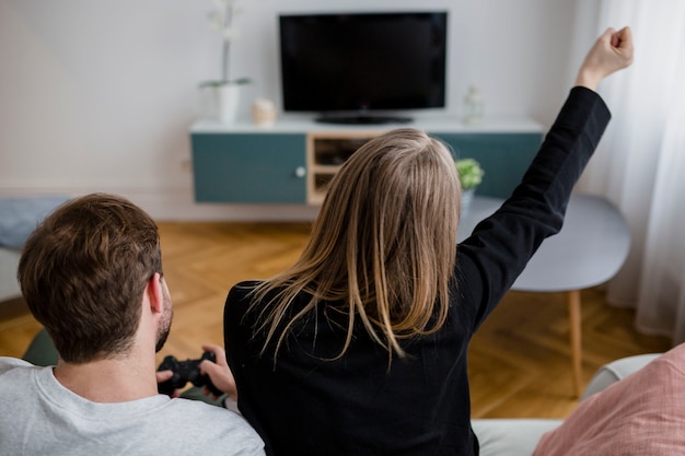 Back view people playing video games