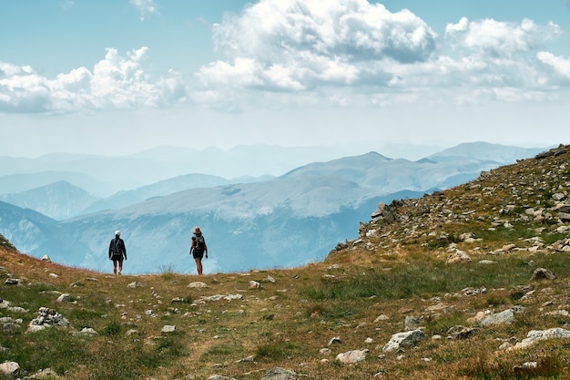 Free photo back view photo of hikers standing at the edge of a hill in the french riviera