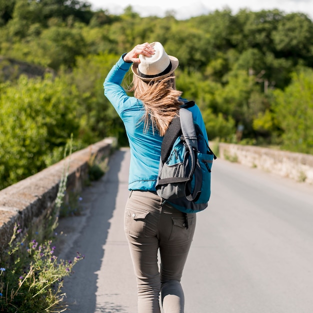 Free Photo back view stylish traveller with hat and backpack