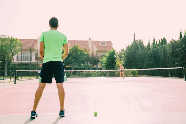 Back view of tennis player on court