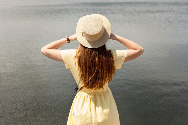 Back view tourist near lake