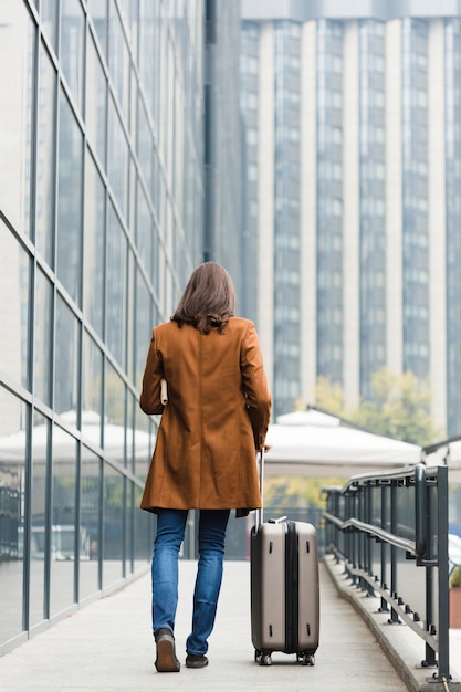 Back view traveler with luggage