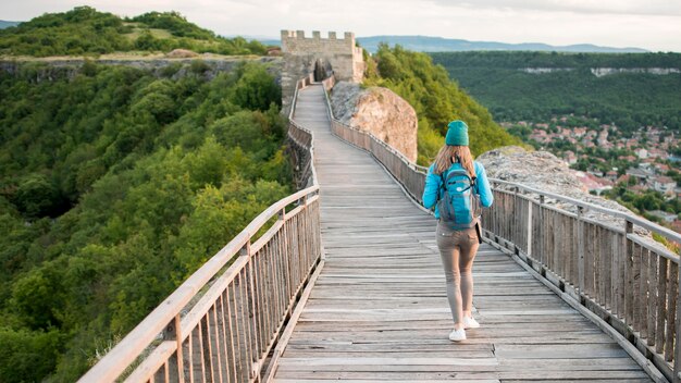 Back view traveller walking down the bridge