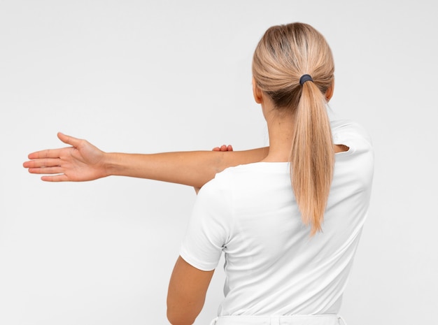 Back view of woman doing physiotherapy exercises