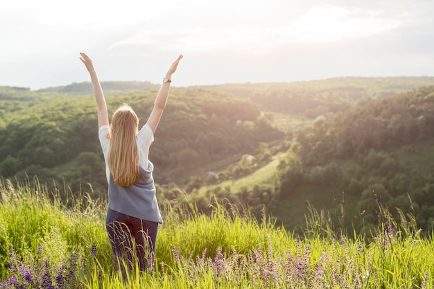 Free photo back view of woman enjoying nature