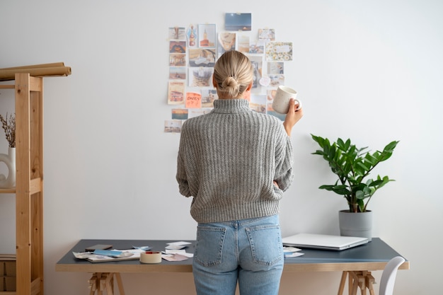 Free Photo back view woman holding coffee cup