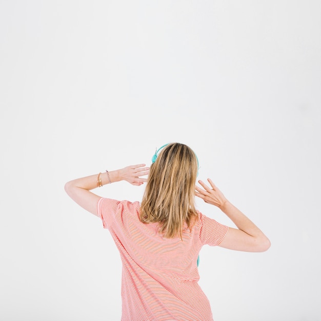 Free photo back view woman listening to music