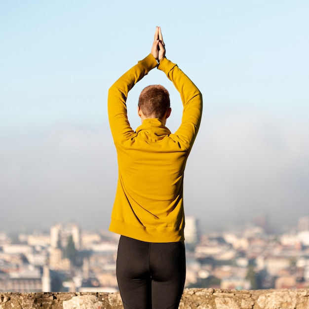 Back view of woman meditating