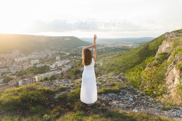 Free photo back view of woman posing in nature