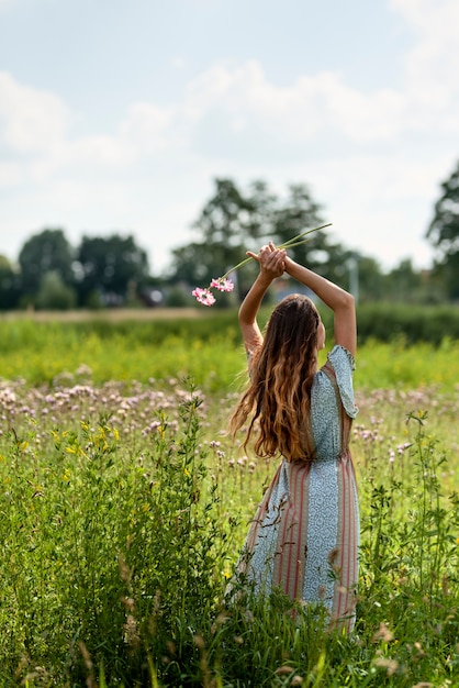 Free Photo back view woman posing in nature