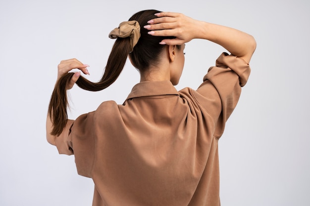 Back view woman posing in studio