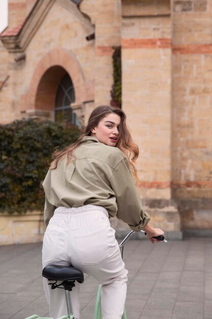 Back view of woman riding bicycle in the city