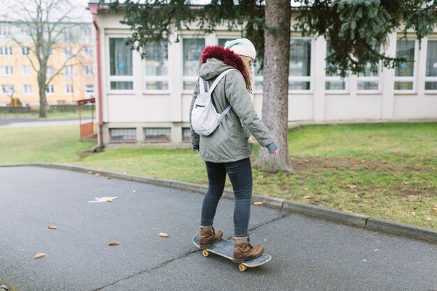 Back view woman on skateboard