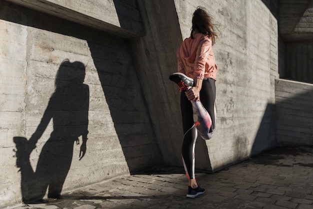 Back view woman stretching before run