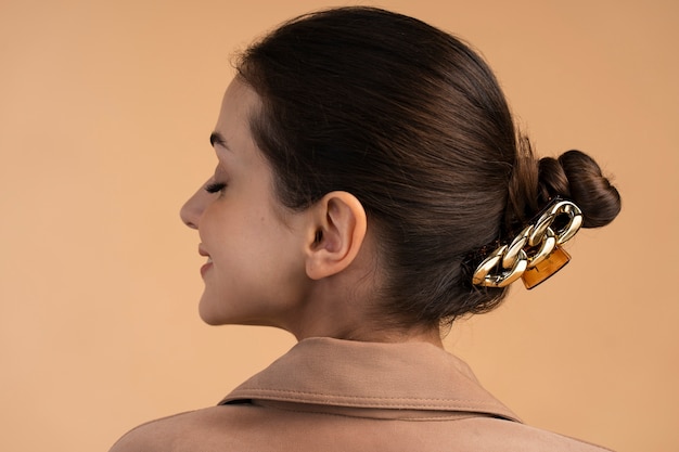 Free Photo back view woman wearing big hair clip