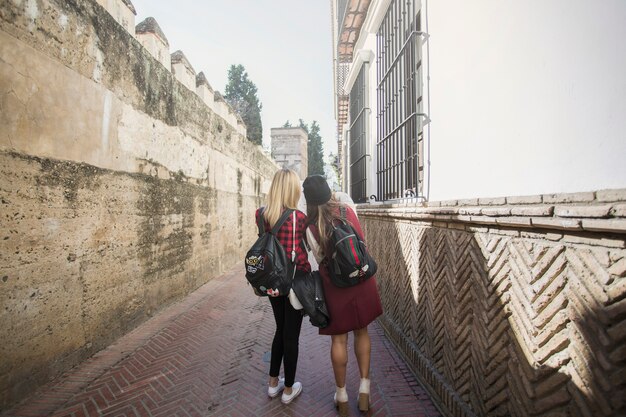 Back view women on narrow street