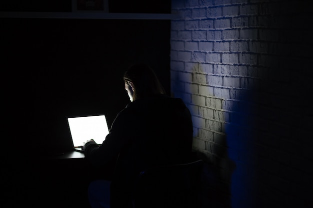 Free Photo back view of young concentrated man using laptop