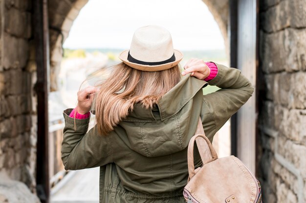 Back view young woman travelling alone