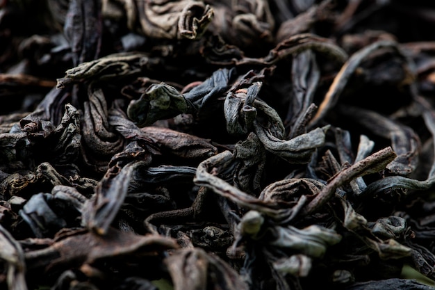 Background of dry black tea leaves texture