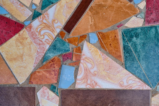 Background from a shard of old mosaic tiles shards of ceramic decorative tiles to create a pattern or background design Idea for decoration of space or wallpaper for advertising