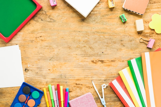 Background of notepads and colorful school supplies