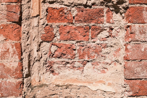 Background of the ruins of an old house a wall of red bricks in salt smudges the texture of natural bricks Grunge background