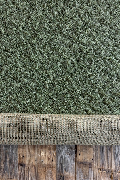 Free photo background of texture of a green carpet with long pile on wooden floor