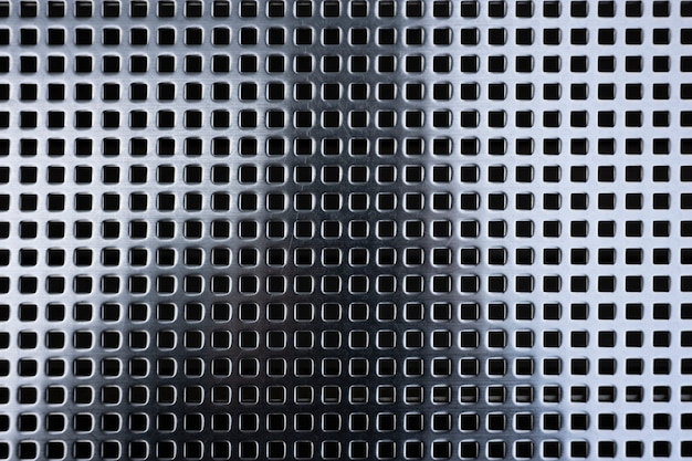 Background with metallic mesh and round holes