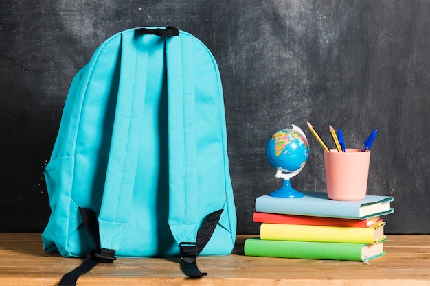 Free photo backpack with books and globe