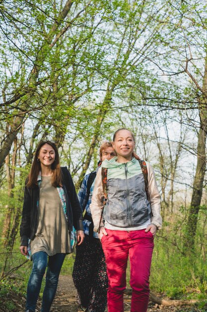 Backpacker friends hiking forest