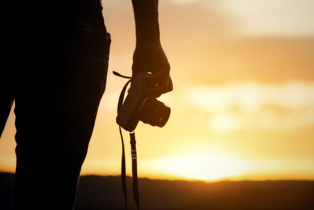 Backpacker relax on the Mountain with camera adn sunset