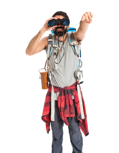 Backpacker with binoculars over isolated white background